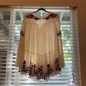 Free people dress: cream/off white in color with bright flower embroidery.